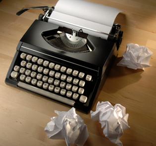 Typemachine met proppen papier ernaast